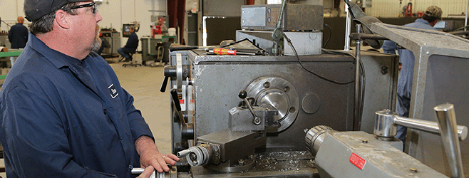 Photo of Tooele worker operating metal machinery